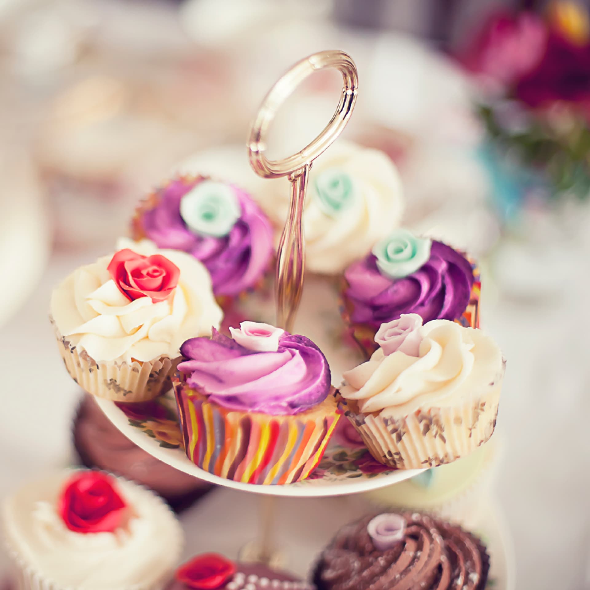 Hochzeits-Cupcakes Bunte, festlich dekorierte Cupcakes auf Etagere