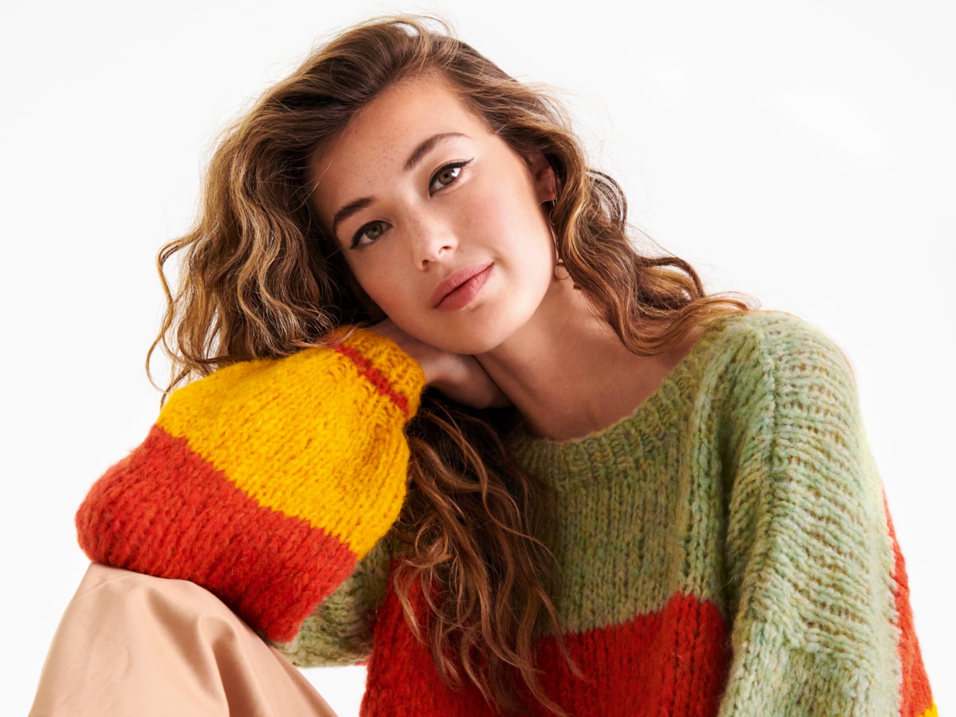 Strickanleitung für den bunten Regenbogen-Pullover Stricken mit Alpakawolle - Model in bunten Regenbogen-Pullover