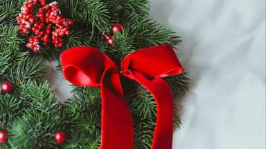 In einer kleinen Wohnung kann die Weihnachtsdeko nicht ganz so üppig ausfallen Adventskranz mit roter Schleife