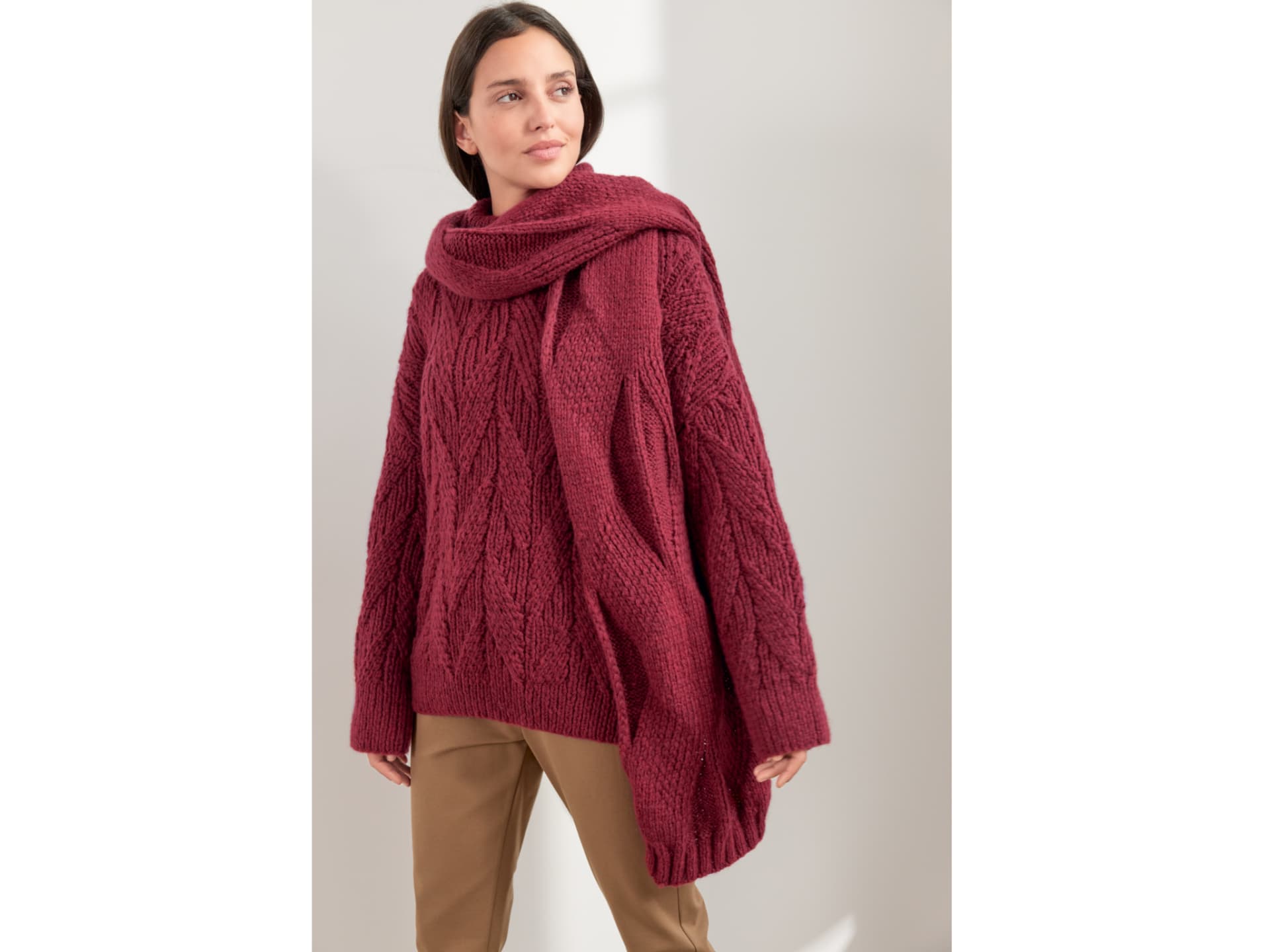 Model in beerenfarbenem Pullover mit Rautenmuster von Lana Grossa Model in beerenfarbenem Pullover mit Rautenmuster von Lana Grossa